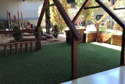 Lush artificial grass lawn beside a paved patio