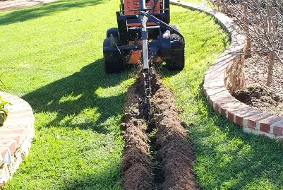 Pop-up reticulation sprinkler watering a green lawn